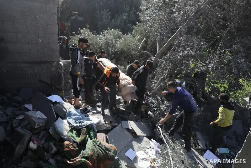 Locals conduct search and rescue operations among the rubble of buildings destroyed by an Israeli attack on Zawaida in Deir al Balah, Gaza on February 22, 2024. Photo by Omar Ashtawy\ apaimages