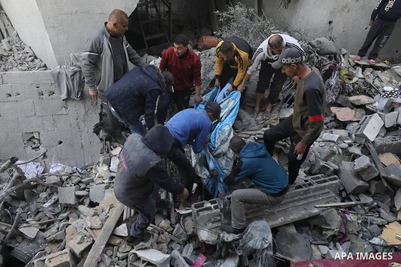 Locals conduct search and rescue operations among the rubble of buildings destroyed by an Israeli attack on Zawaida in Deir al Balah, Gaza on February 22, 2024. Photo by Omar Ashtawy\ apaimages