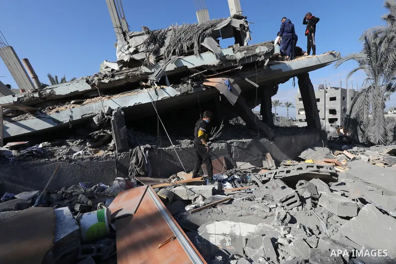 Locals conduct search and rescue operations among the rubble of buildings destroyed by an Israeli attack on Zawaida in Deir al Balah, Gaza on February 22, 2024. Photo by Omar Ashtawy\ apaimages
