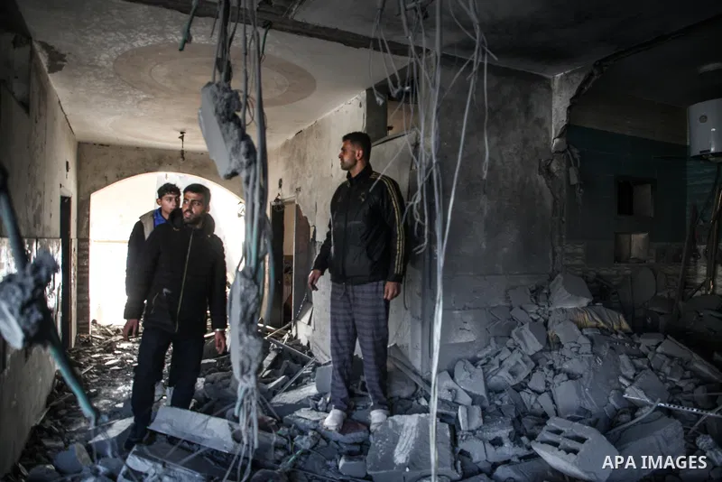 Palestinian artist Mahmoud Zuaiter inspects the ruins of his house after an air strike on the house in Deir al-Balah in the central Gaza Strip on February 24, 2024. Photo by Bashar Taleb\ apaimages