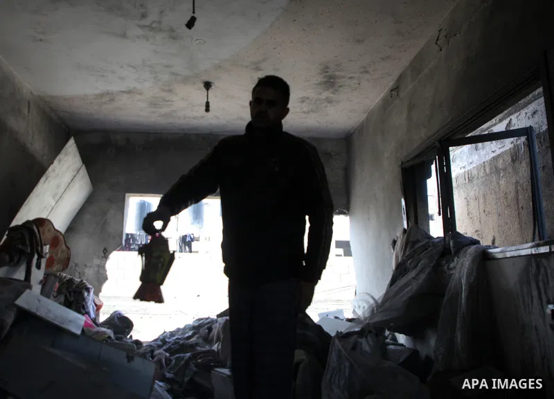 Palestinian artist Mahmoud Zuaiter inspects the ruins of his house after an air strike on the house in Deir al-Balah in the central Gaza Strip on February 24, 2024. Photo by Bashar Taleb\ apaimages