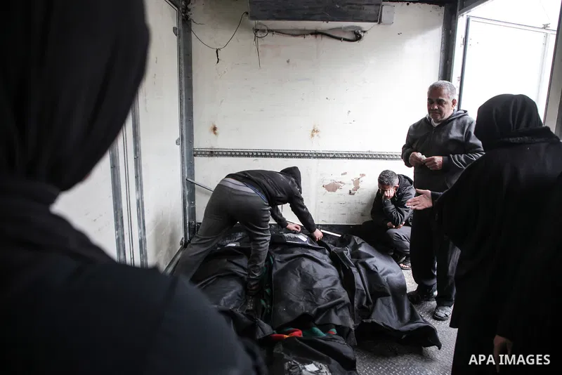 Relatives of the Palestinians died in Israeli attacks, mourn as they receive the dead bodies from the morgue of Al-Aqsa Hospital for burial in Dair El-Balah, Gaza on February 24, 2024. Photo by Bashar Taleb\ apaimages