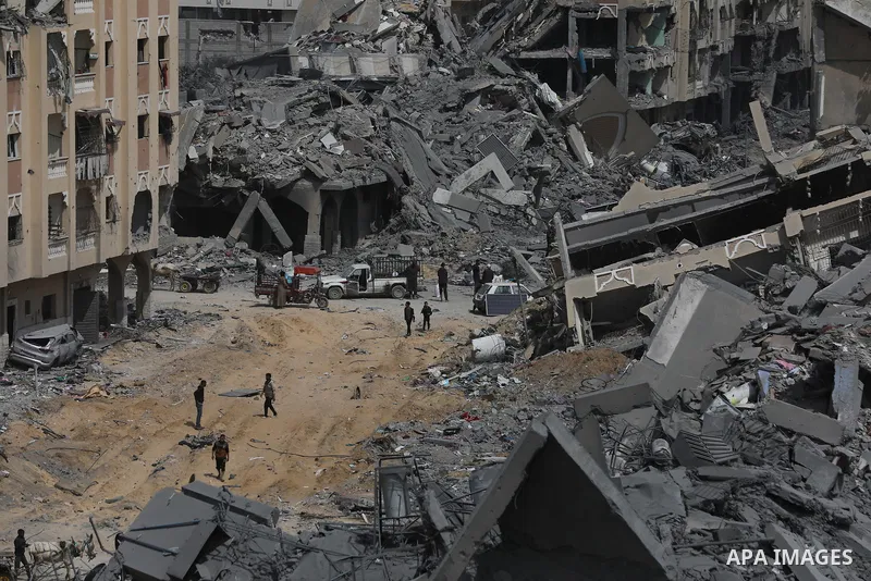 Palestinians inspect damage of the destroyed buildings belonged in the Hamad City, following the Israeli attack on the Khan Yunis, Gaza Strip on March 14, 2024. Photo by Naaman Omar\ apaimages