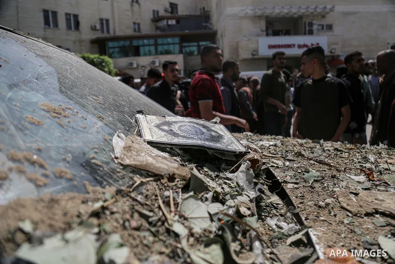 Palestinians check the damage at a makeshift camp for displaced people in front of the Al-Aqsa Martyrs Hospital in Deir al-Balah in the central Gaza Strip, after it was hit by Israel bombardment on March 31, 2024. photo...