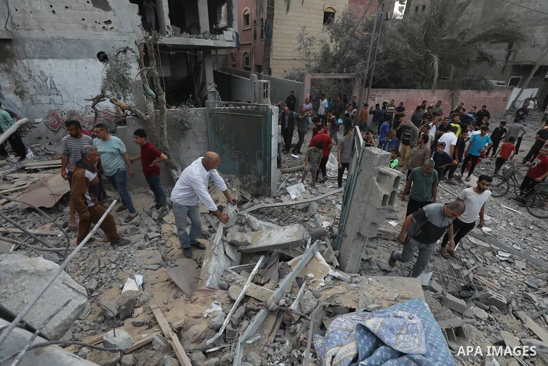 Palestinians look at the destruction after an Israeli airstrike in Deir al Balah, Gaza Strip, Tuesday, April 30, 2024. Photo by Omar Ashtawy\ apaimages