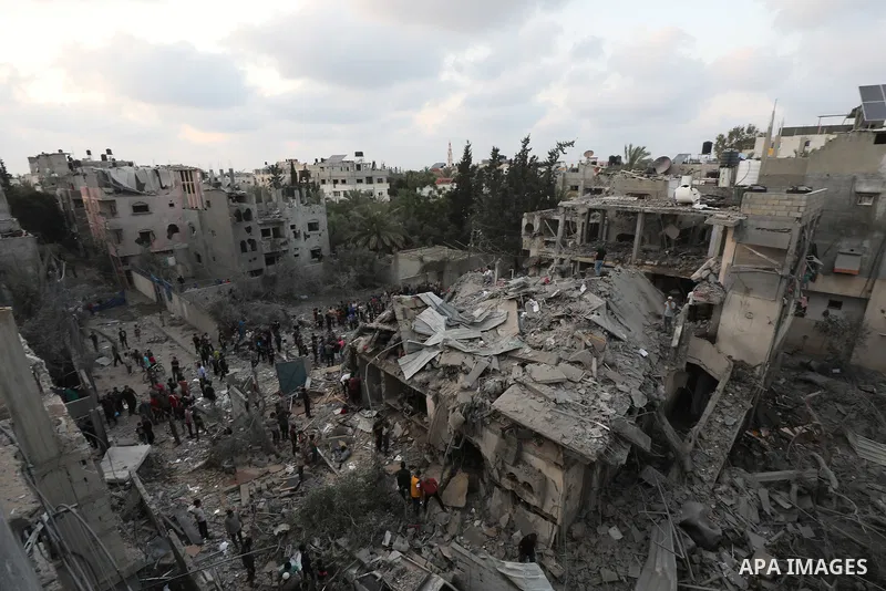 Palestinians look at the destruction after an Israeli airstrike in Deir al Balah, Gaza Strip, Tuesday, April 30, 2024. Photo by Omar Ashtawy\ apaimages