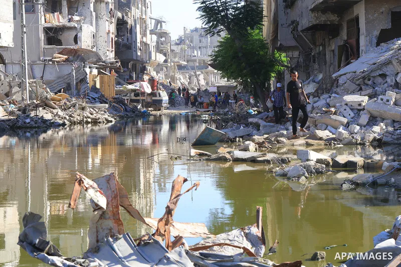 Sewage water is seen in the middle of a street between destroyed buildings in the southern Gaza Strip city of Khan Younis, on July 03, 2024. Health conditions in the Palestinian coastal enclave of Gaza Strip keep worseni...