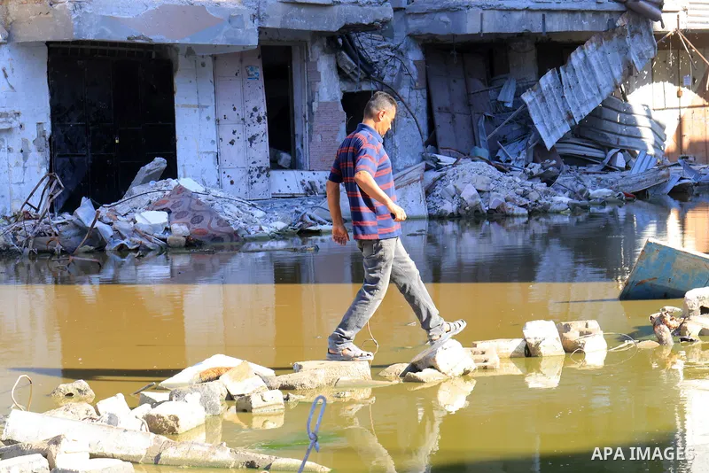 Sewage water is seen in the middle of a street between destroyed buildings in the southern Gaza Strip city of Khan Younis, on July 03, 2024. Health conditions in the Palestinian coastal enclave of Gaza Strip keep worseni...