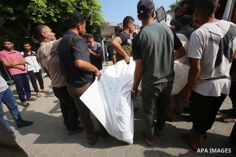 Relatives of the Palestinians died in Israeli attacks, mourn as they receive the dead bodies from the morgue of Al-Aqsa Hospital for burial in Dair El-Balah, Gaza on July 18, 2024. Photo by Ali Hamad\ apaimages