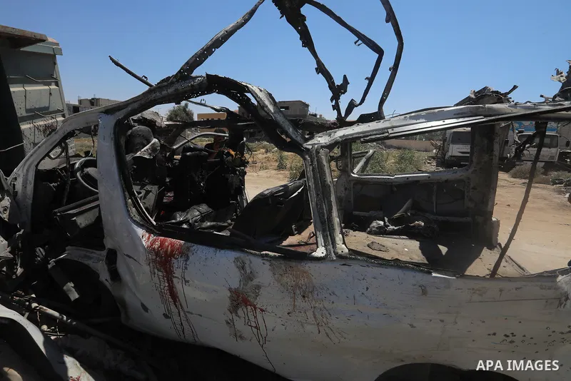 Palestinians inspect the destroyed vehicle after an Israeli attack in Al_Zawaida, Gaza on July 31, 2024. Deaths and injuries were reported after the attack at the location. Photo by Omar Ashtawy\ apaimages