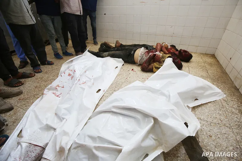 Palestinians carry the bodies of men killed after an Israeli air strike targeted a vehicle in EL-Zawayide area in Gaza City, Gaza on July 31, 2024. Israeli forces targeted a vehicle in EL-Zawayide town in the central Gaz...