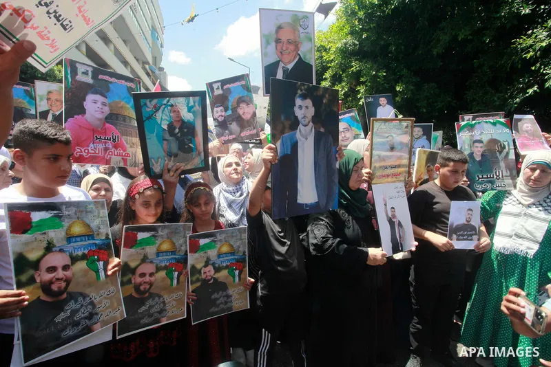 People chant slogans and hold placards during a demonstration in Nablus, in the occupied West Bank, on August 3, 2024, in solidarity with the people of Gaza and Palestinians detained in Israeli prisons, amid the ongoing...