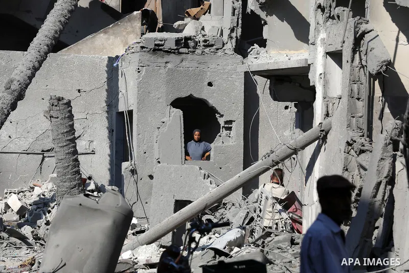 Palestinians check the destruction in Deir el-balah in the central Gaza Strip, on August 7, 2024, following Israeli bombardment amid the ongoing conflict between Israel and the Palestinian Hamas militant group. Photo by...