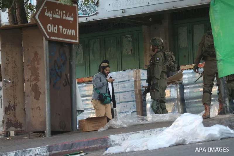 Israeli army forces close commercial markets in the city of Hebron and expel Palestinians from the vicinity of the market in the center of the city, on 13 August 2024. The army is implementing this closure to allow settl...