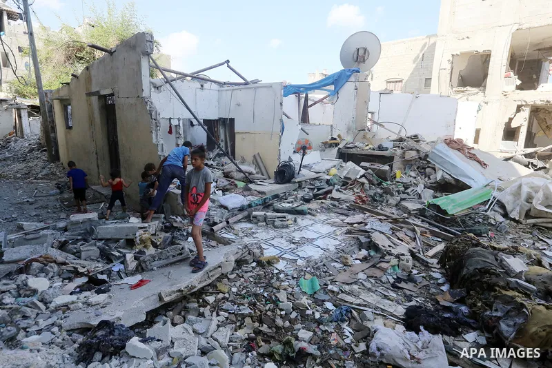 Palestinians inspect the site following the Israeli attack, in Al-Maghazi Refugee Cam, Gaza on August 14, 2024. The Israeli army attacked the building where the Eid family is located in the Al-Maghazi Refugee Camp in the...