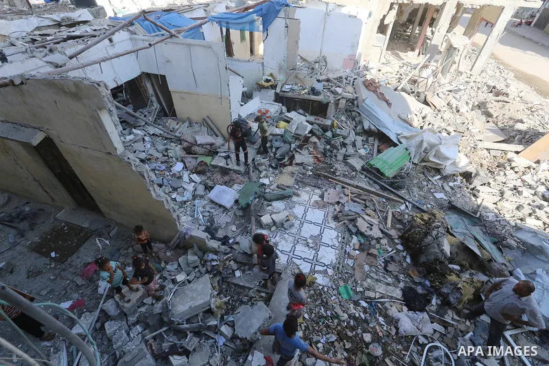 Palestinians inspect the site following the Israeli attack, in Al-Maghazi Refugee Cam, Gaza on August 14, 2024. The Israeli army attacked the building where the Eid family is located in the Al-Maghazi Refugee Camp in the...