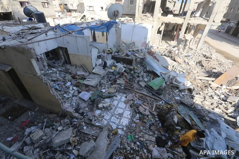 Palestinians inspect the site following the Israeli attack, in Al-Maghazi Refugee Cam, Gaza on August 14, 2024. The Israeli army attacked the building where the Eid family is located in the Al-Maghazi Refugee Camp in the...