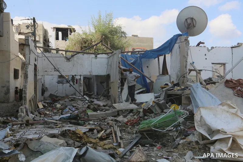 Palestinians inspect the site following the Israeli attack, in Al-Maghazi Refugee Cam, Gaza on August 14, 2024. The Israeli army attacked the building where the Eid family is located in the Al-Maghazi Refugee Camp in the...