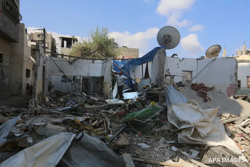 Palestinians inspect the site following the Israeli attack, in Al-Maghazi Refugee Cam, Gaza on August 14, 2024. The Israeli army attacked the building where the Eid family is located in the Al-Maghazi Refugee Camp in the...
