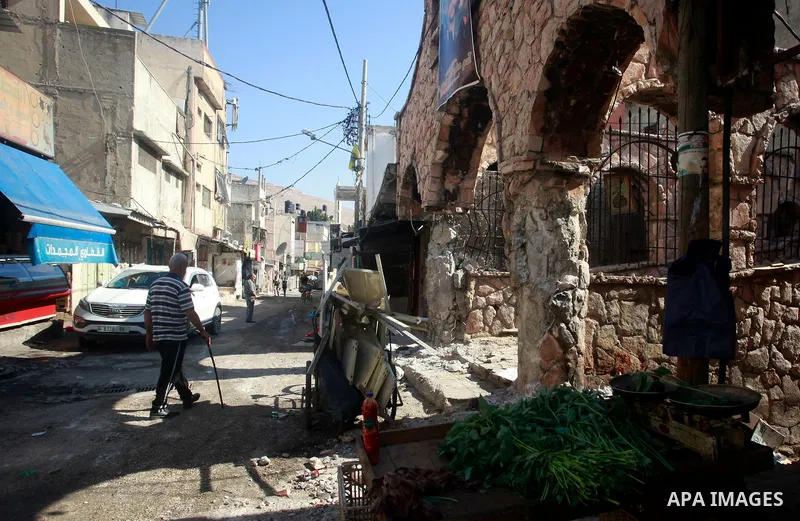Palestinians walk past damage caused by Israeli army forces during a raid on the Balata refugee camp, near the West Bank city of Nablus, August 18, 2024. Photo by Mohammed Nasser\ apaimages