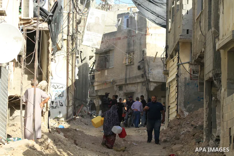 Palestinians walk amid the devastation following an Israeli army raid in Tulkarem in the north of the occupied-West Bank, on September 15, 2024. Photo by Mohammed Nasser\ apaimages