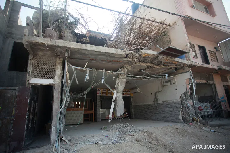 Palestinians walk past an office of UNRWA demolished by Israeli forces in the Nur Shams camp, east of Tulkarm city in the northern West Bank, on Nov. 02, 2024. The Israeli army on Thursday demolished the office of the Un...