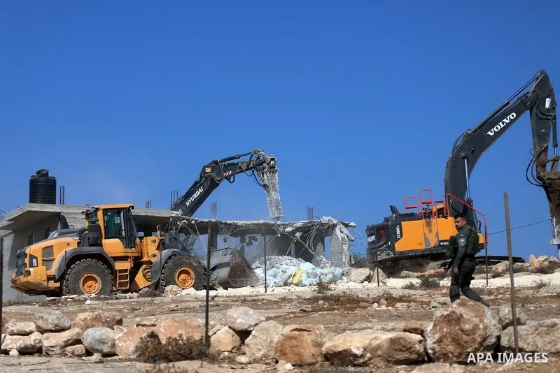 Israeli bulldozers under the supervision of the army, demolish two Palestinian houses in southern Yatta, south of Hebron, in the Israeli occupied West Bank on November 06, 2024. Israeli army forces demolished two houses...