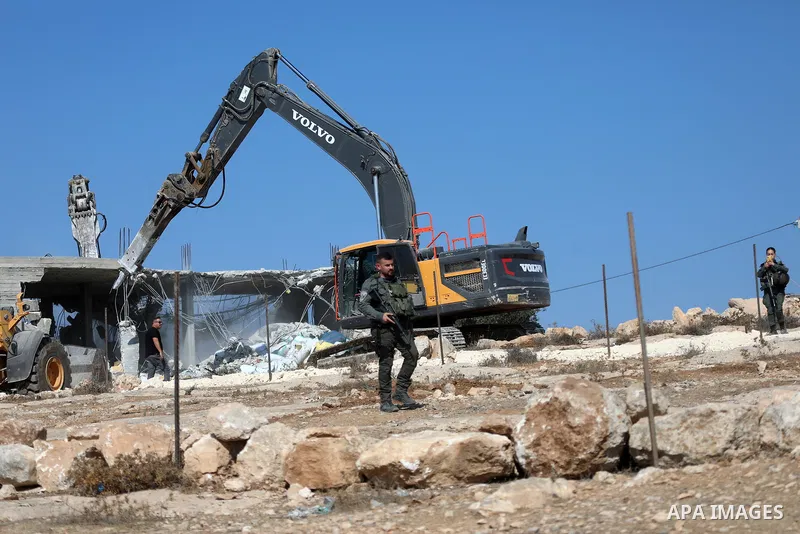 Israeli bulldozers under the supervision of the army, demolish two Palestinian houses in southern Yatta, south of Hebron, in the Israeli occupied West Bank on November 06, 2024. Israeli army forces demolished two houses...