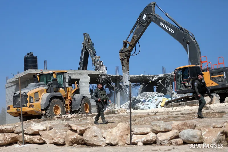 Israeli bulldozers under the supervision of the army, demolish two Palestinian houses in southern Yatta, south of Hebron, in the Israeli occupied West Bank on November 06, 2024. Israeli army forces demolished two houses...