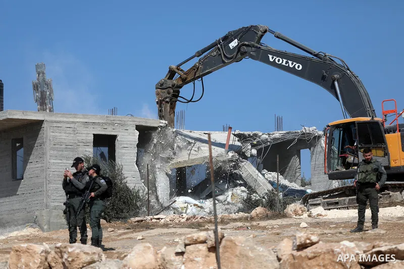 Israeli bulldozers under the supervision of the army, demolish two Palestinian houses in southern Yatta, south of Hebron, in the Israeli occupied West Bank on November 06, 2024. Israeli army forces demolished two houses...