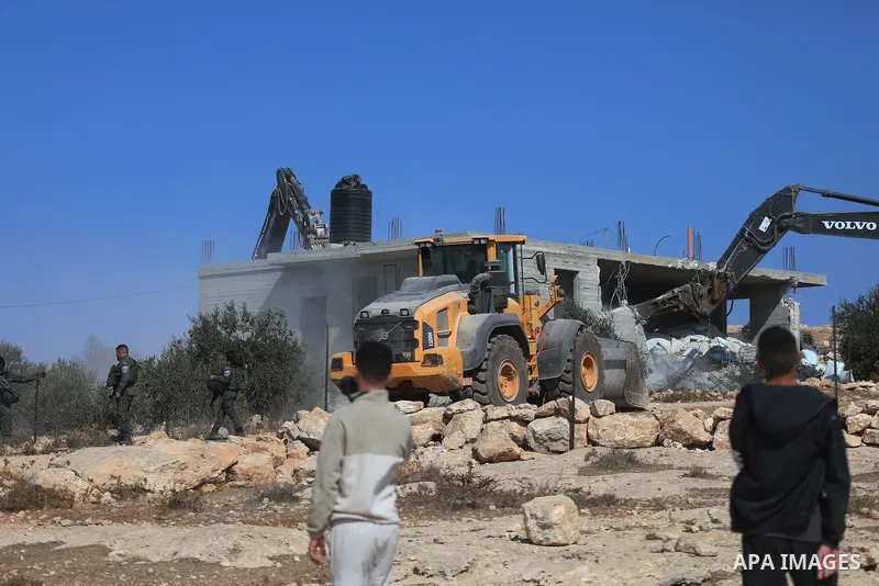 Israeli bulldozers under the supervision of the army, demolish two Palestinian houses in southern Yatta, south of Hebron, in the Israeli occupied West Bank on November 06, 2024. Israeli army forces demolished two houses...