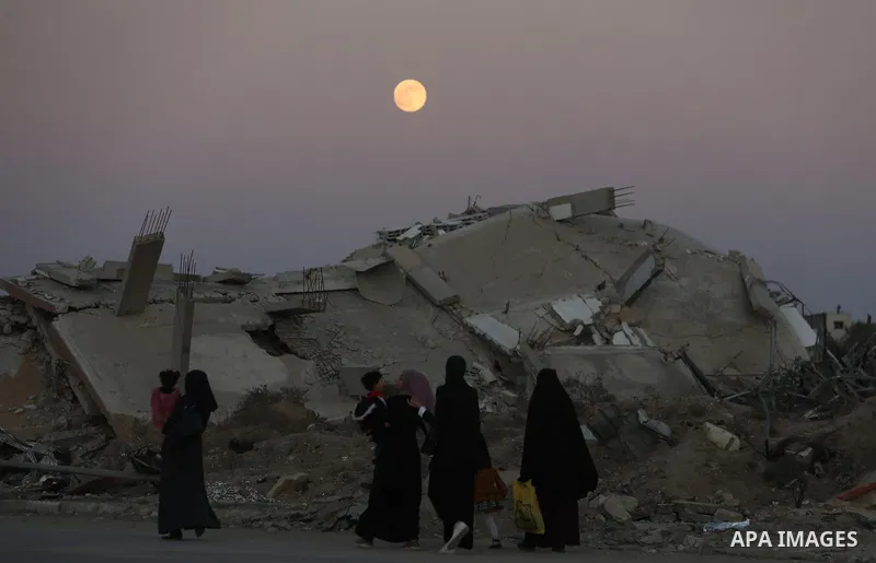 A full moon rises over destroyed buildings in the Zawaida eara in the central of Gaza Strip early on November 15, 2024, amid the ongoing conflict between Israel and the Palestinian Hamas militant group. Photo by Ali Hama...