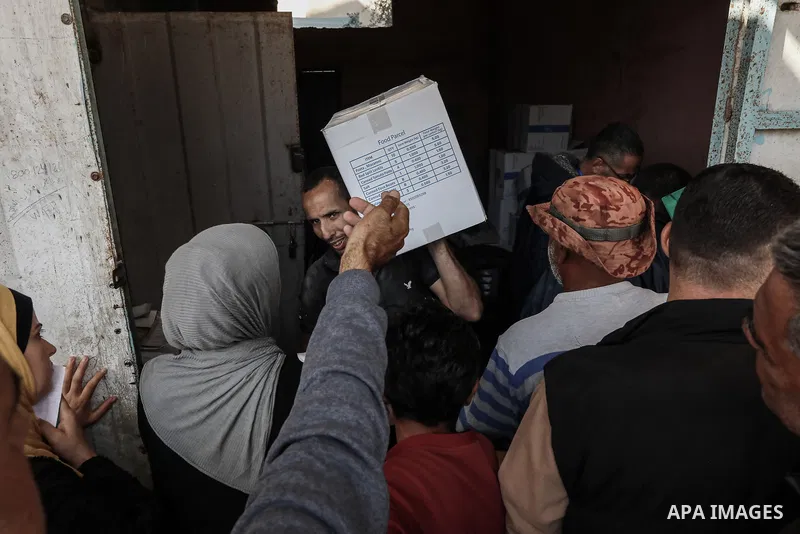 Palestinians transport boxs of humanitarian aid, supplied by the World Food Program, back to his home in Dair El-Balah in the central Gaza Strip on November 20, 2024, amid the ongoing war between Israel and the Hamas mil...