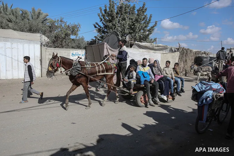 Displaced people use animal-drawn carts for transportation in Dair El-Balah in the central Gaza Strip on November 20, 2024, as the war between Israel and the Palestinian Hamas movement continues in the besieged territory...