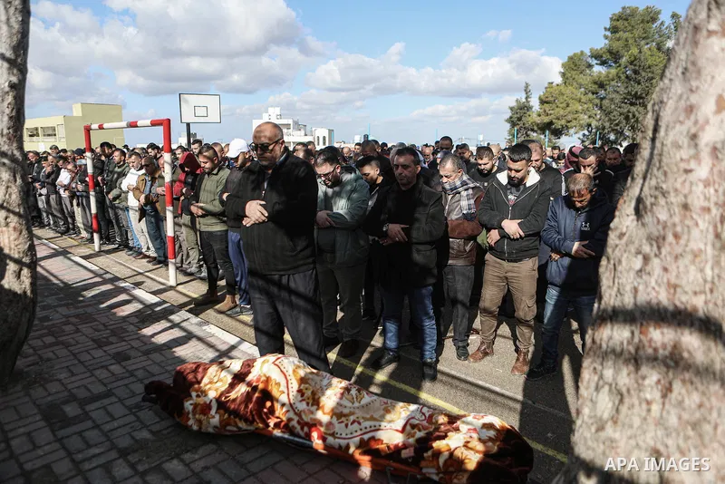 Palestinians carry the body of martyr Muhammad Masalma, 32, in the village of Beit Awa, west of the West Bank city of Hebron, on December 14, 2024. Photo by Mamoun Wazwaz