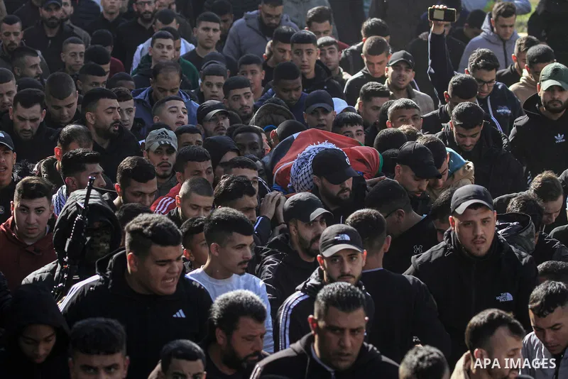 Mourners carry the body of Mohammed Yasser Abu Kishk, who was killed in clashes with Israeli forces, during his funeral at the Asker camp for Palestinian refugees east of Nablus city in the occupied West Bank on December...