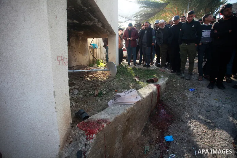 Palestinians inspect bloodstains and debris outside a house in the northern West Bank village of Tamoun, after an Israeli drone strike killed three members of a Palestinian family, January 8, 2025. Photo by Mohammed Nass...