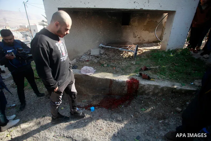 Palestinians inspect bloodstains and debris outside a house in the northern West Bank village of Tamoun, after an Israeli drone strike killed three members of a Palestinian family, January 8, 2025. Photo by Mohammed Nass...