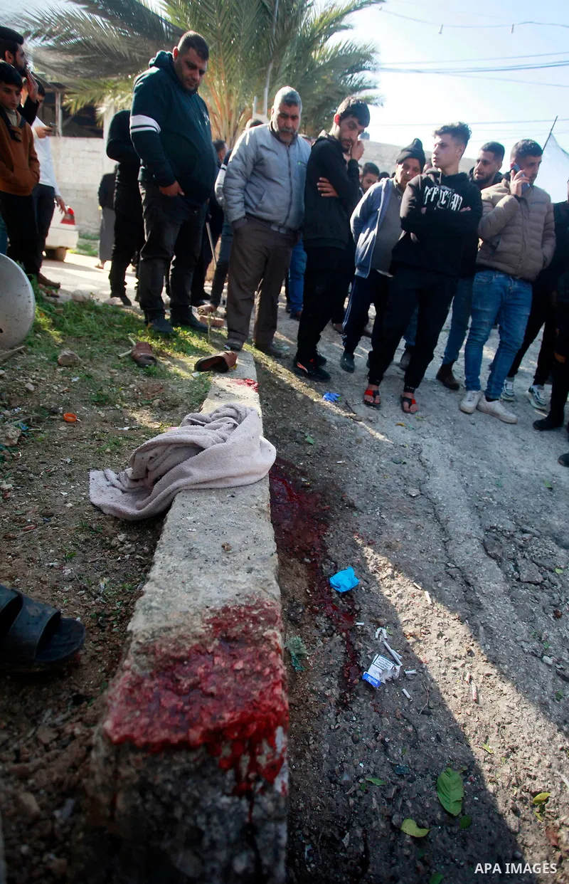 Palestinians inspect bloodstains and debris outside a house in the northern West Bank village of Tamoun, after an Israeli drone strike killed three members of a Palestinian family, January 8, 2025. Photo by Mohammed Nass...