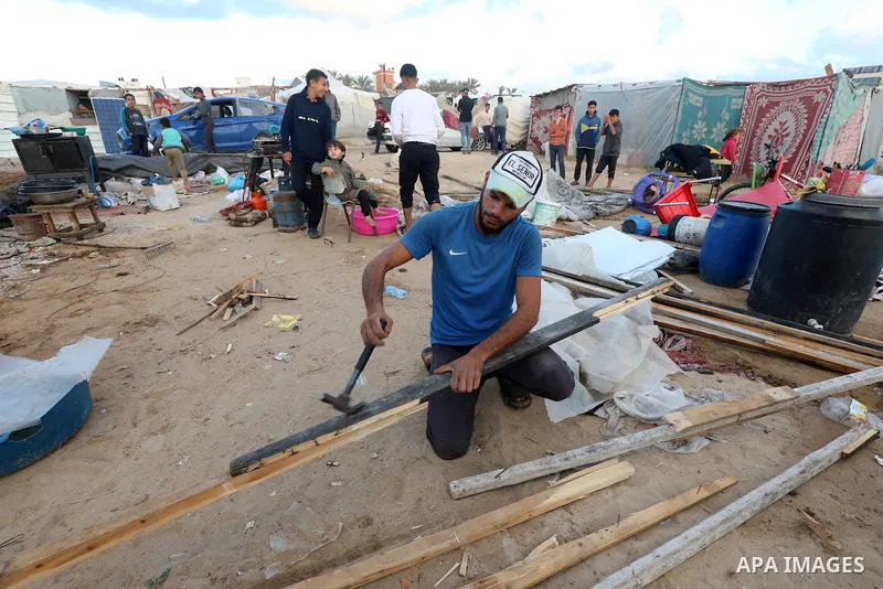 Displaced Palestinians dismantle their tents at a makeshift camp in Al-Zawayda, in the central Gaza Strip on January 24, 2025, as they prepare to return back to their homes in the northern Gaza Strip after a ceasefire de...