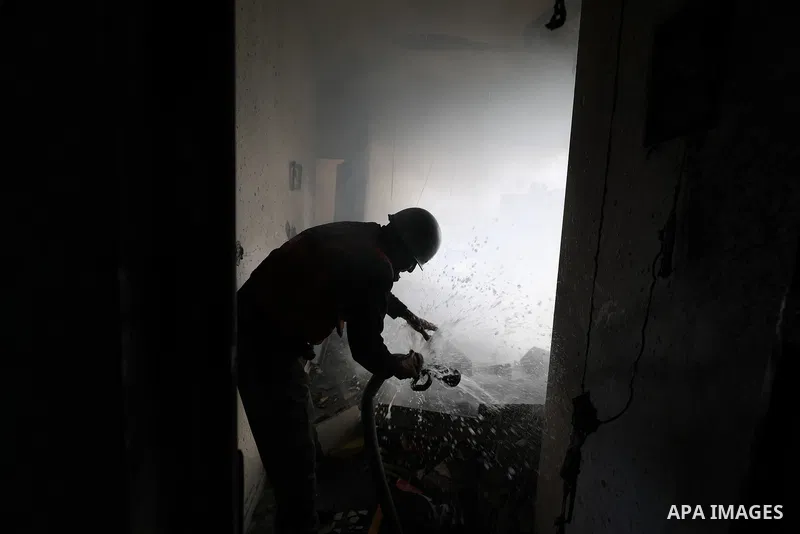 Emergency teams try to put out the fire broke out in an apartment after Israeli army's attack in the Bureij Refugee Camp of Gaza despite the ceasefire agreement signed between Hamas and Israel on March 19, 2025. Photo by...