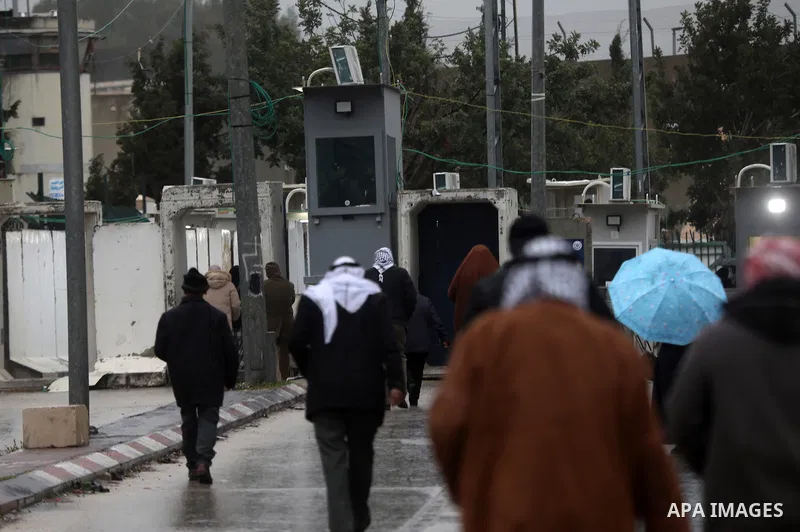 Palestinians, living in West Bank, gather at the Israeli military checkpoint separating Bethlehem and Jerusalem from the early hours of the morning to perform the third Friday prayer of Ramadan at Al-Aqsa Mosque on March...
