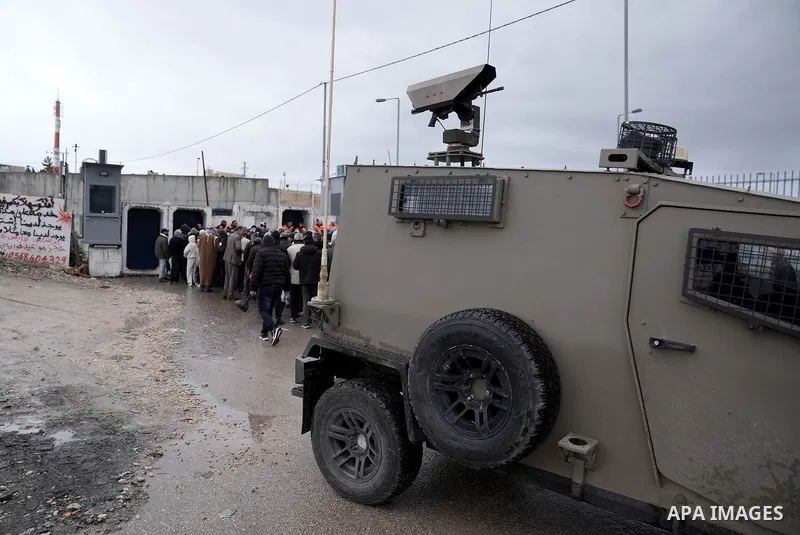 Palestinians, living in West Bank, gather at the Qalendiya military checkpoint separating Ramallah and Jerusalem from the early hours of the morning to perform the third Friday prayer of Ramadan at Al-Aqsa Mosque on Marc...
