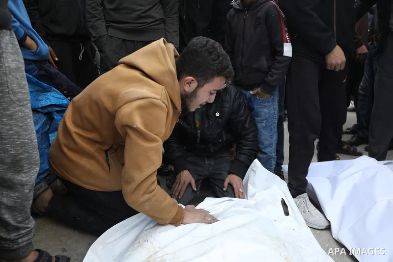 People mourn during the funeral for members of the Palestinian Abu al-Rous family who were killed when their house was hit by Israeli bombardment, at the Bureij camp for Palestinian refugees in the central Gaza Strip on...