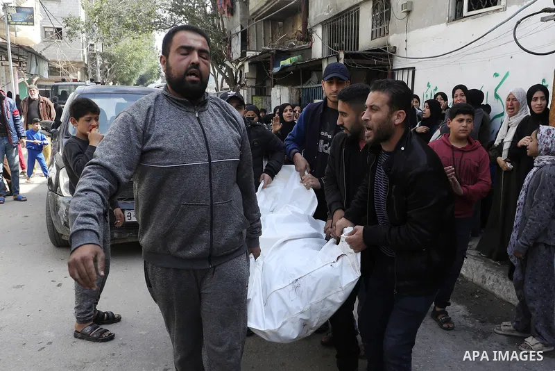 People mourn during the funeral for members of the Palestinian Abu al-Rous family who were killed when their house was hit by Israeli bombardment, at the Bureij camp for Palestinian refugees in the central Gaza Strip on...