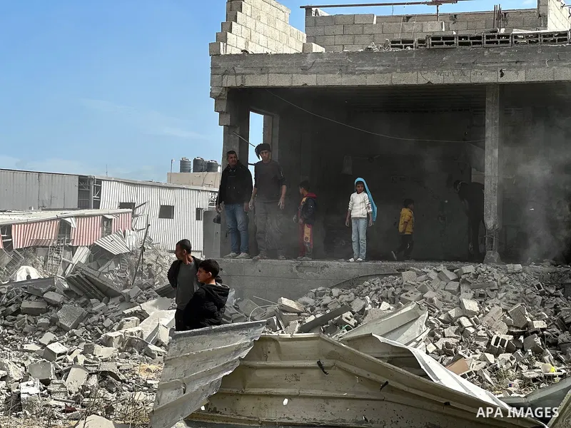 Palestinians inspect the site of an Israeli strike on tents and buildings site housing displaced people, in Khan Younis, in the southern Gaza Strip, April 13, 2025. Photo by Doaa el-Baz\ apaimages