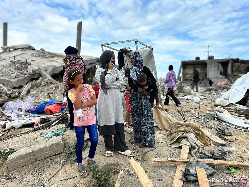 Palestinians inspect the site of an Israeli strike on tents and buildings site housing displaced people, in Khan Younis, in the southern Gaza Strip, April 13, 2025. Photo by Doaa el-Baz\ apaimages
