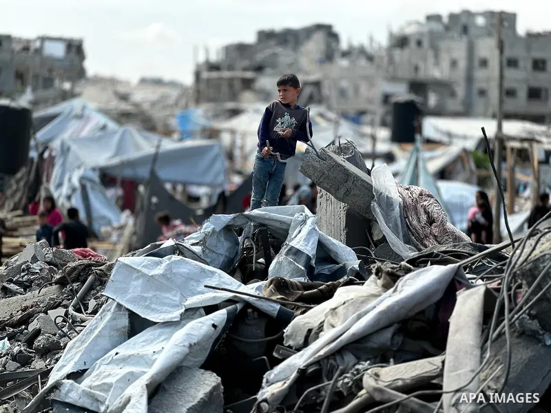 Palestinians inspect the site of an Israeli strike on tents and buildings site housing displaced people, in Khan Younis, in the southern Gaza Strip, April 13, 2025. Photo by Doaa el-Baz\ apaimages