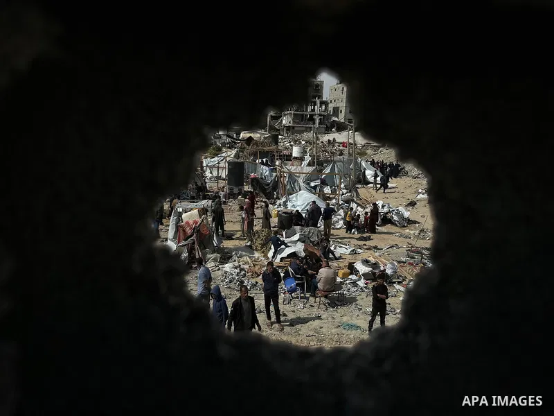 Palestinians inspect the site of an Israeli strike on tents and buildings site housing displaced people, in Khan Younis, in the southern Gaza Strip, April 13, 2025. Photo by Doaa el-Baz\ apaimages