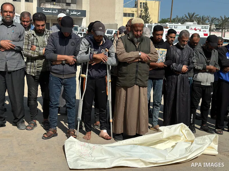 Relatives of Palestinian children, who lost their lives after Israeli attacks targeted Palestinians staying in houses and makeshift tents, mourn over the dead bodies of them following brought them to the morgue of the Na...
